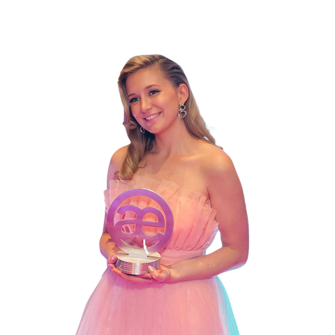 A striveX team member holding an industry award