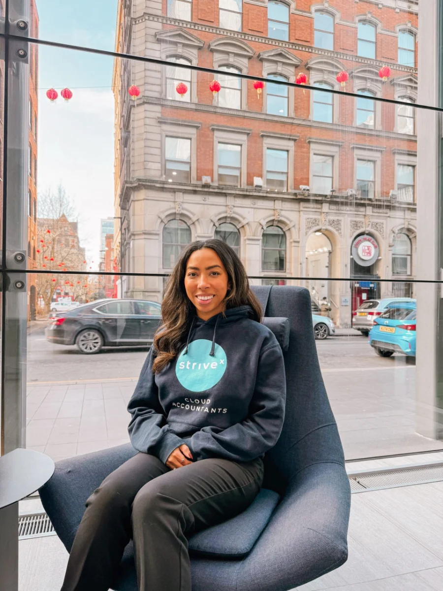 A striveX team member sitting by a window overlooking a city street