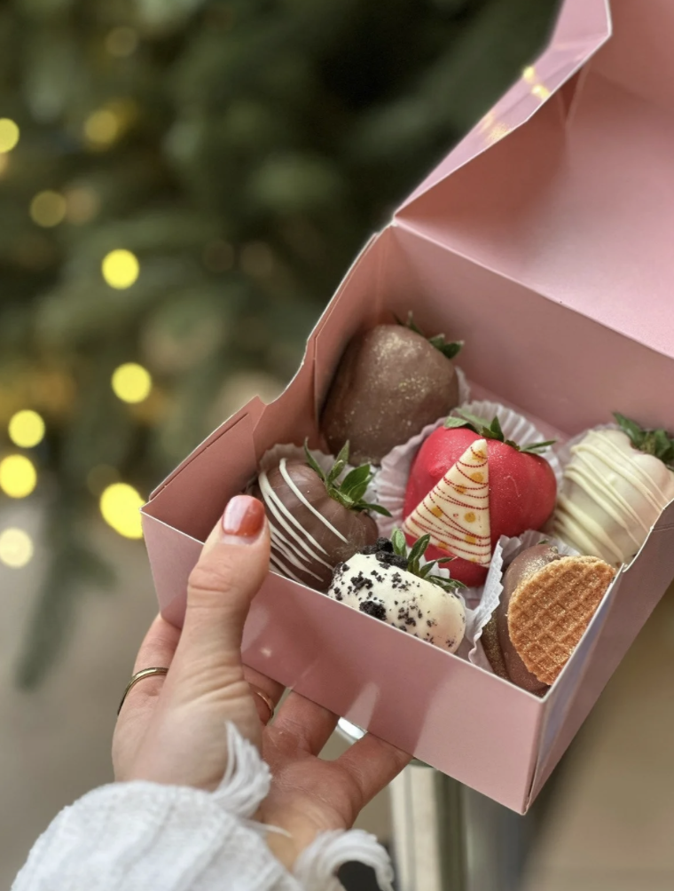 Box of assorted chocolate-dipped strawberries from Chocofruit, held open to show the selection